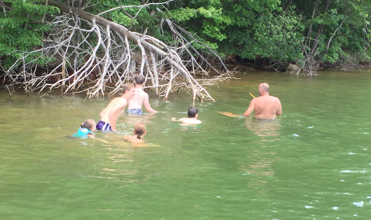 Family enjoying a guided noodling tour in the river